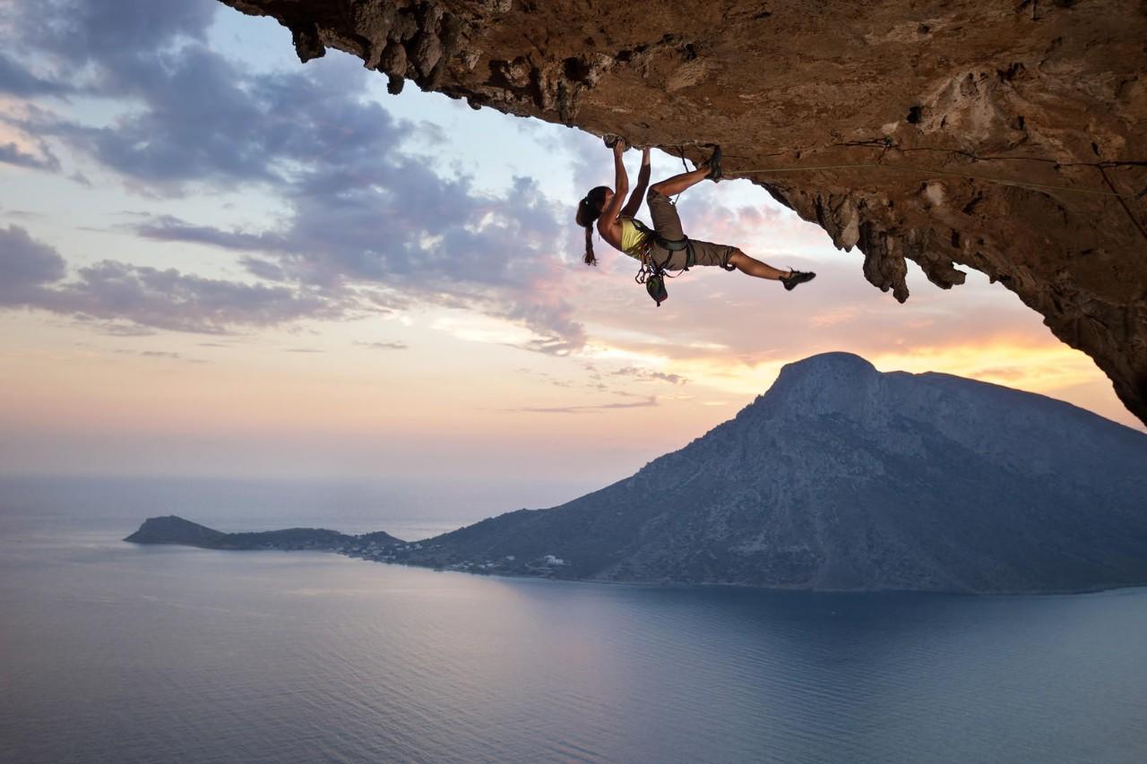 Female rock climber at sunset, Kalymnos Island, Greece